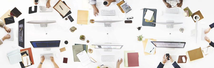 Office desk with computers and mobile devices